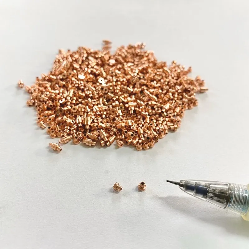 C1100 紅銅微型件 Ø2.5×2.5mm，旁為筆尖對照